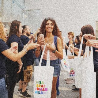 A girl carrying shopping leaves an Apple store in Milan