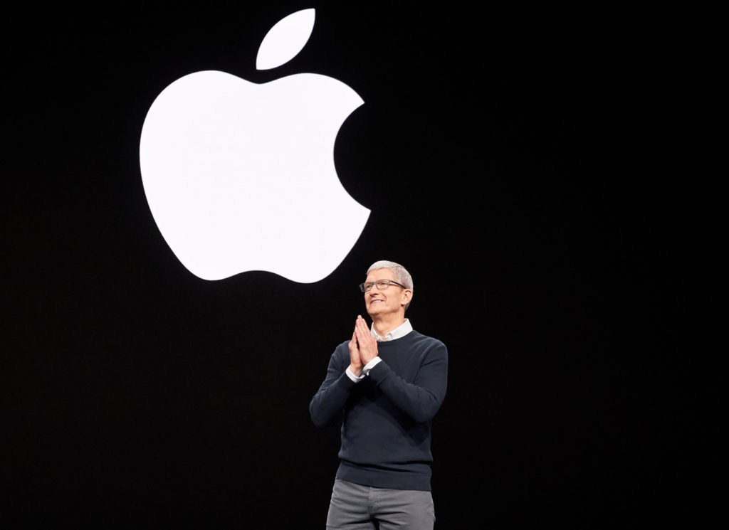 Tim Cook under Apple logo