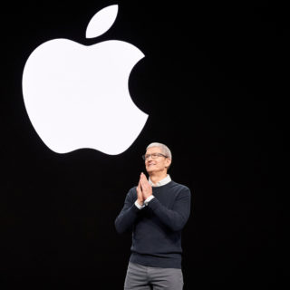 Tim Cook under Apple logo