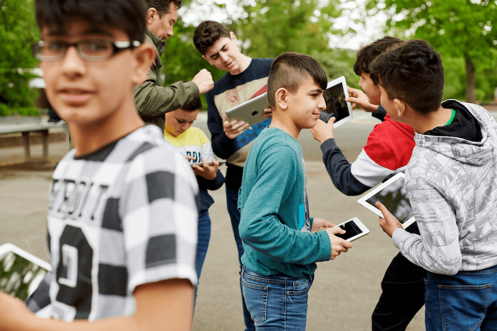 This image shows children using iPads to talk