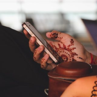 A hand holds an iPhone